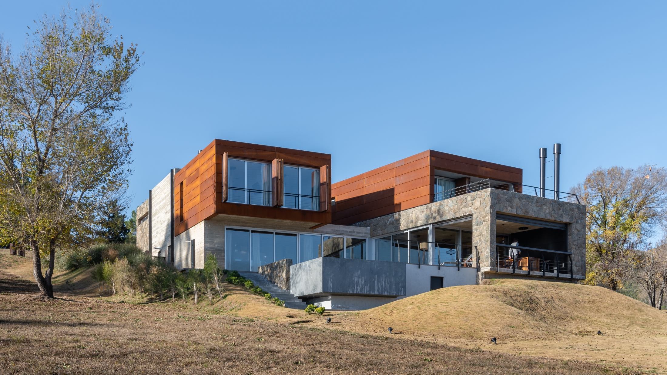 house on a hill surrounded with trees